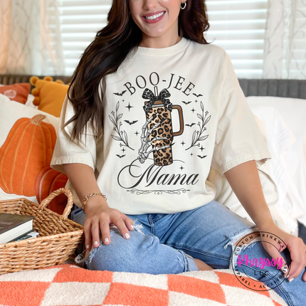Woman wearing a ivory graphic tee with a boo-jee mama design.