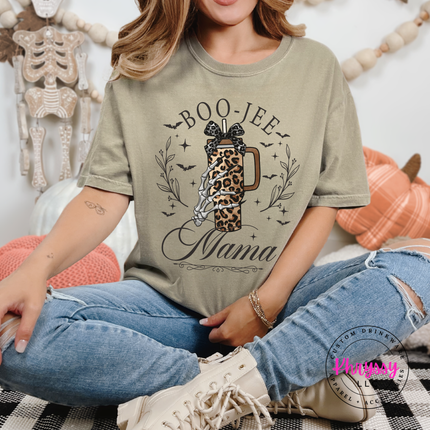 khaki tee featuring a skeleton hand holding a leopard tumbler.