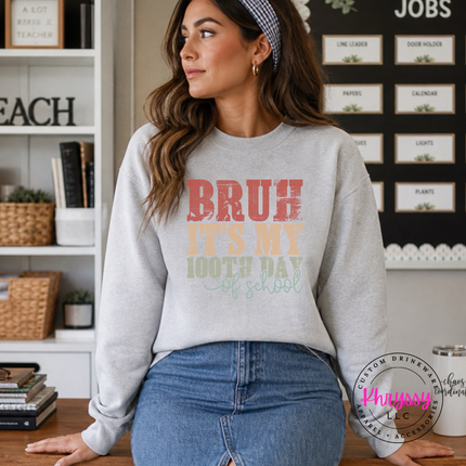 Ash grey crewneck sweatshirt with a distressed 100th day of school print.