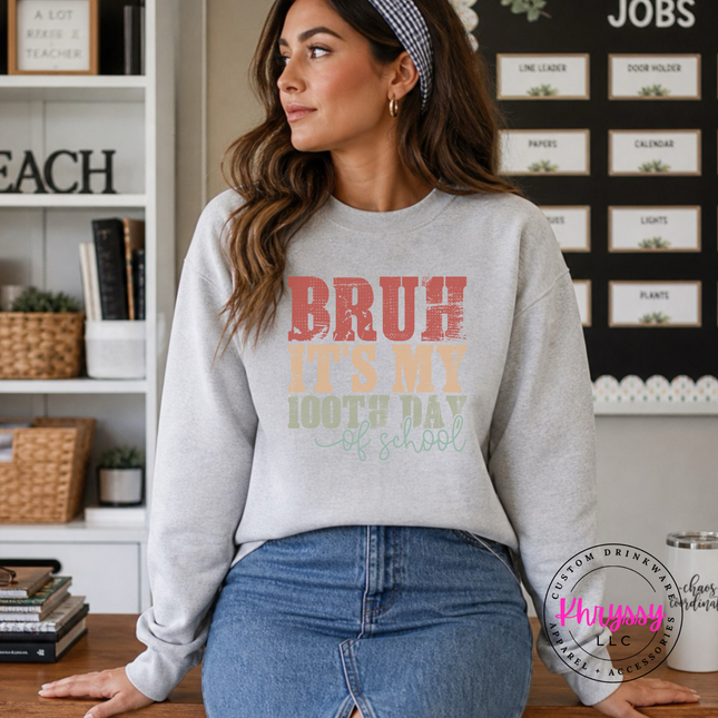 Ash grey crewneck sweatshirt with a distressed 100th day of school print.
