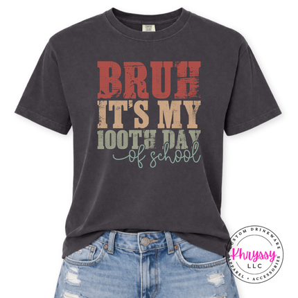 Graphite soft tee styled with a weathered bruh 100th day graphic.