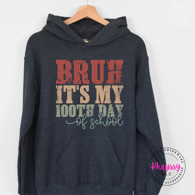 Dark heather heavyweight hoodie styled with a weathered 100th day graphic.
