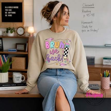 Sand crewneck sweatshirt showing doodled hearts and paper airplanes.