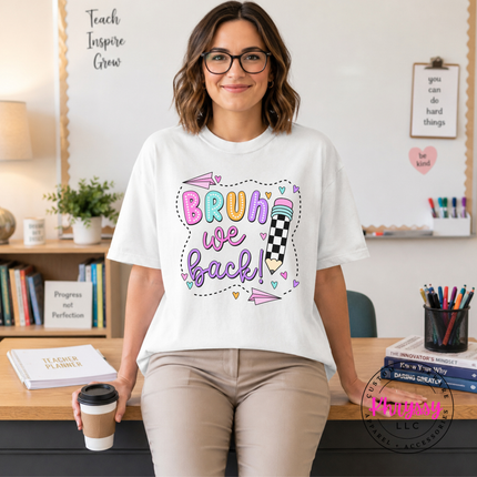 White cotton tee showing the bright Bruh We Back first-day-of-school print.