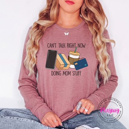 Woman wearing a Heather Mauve long sleeve tee with the doing mom stuff graphic