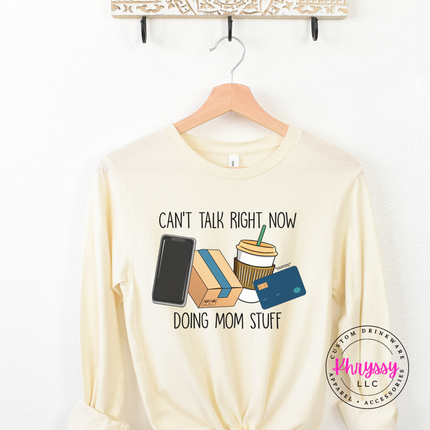 Natural long sleeve tee showing the can't talk right now doing mom stuff graphic
