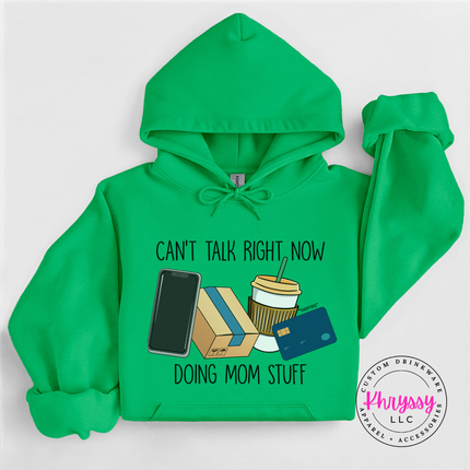 Folded Irish Green hoodie showing the funny can't talk right now doing mom stuff graphic
