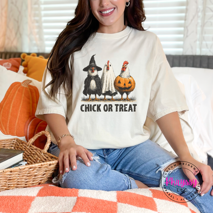 Ivory tee featuring a witch, ghost, and pumpkin chicken Halloween design.