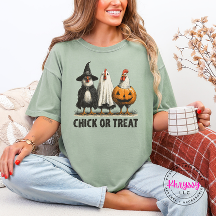 Woman wearing a bay Chick Or Treat Halloween chicken graphic tee outdoors.