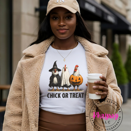 Woman wearing a 'Chick or Treat' shirt with cartoon characters, holding a coffee cup outdoors.