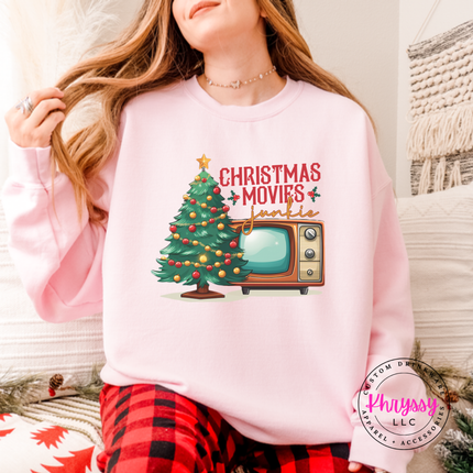 Flat lay of the Christmas movie junkie Christmas crewneck sweatshirt in Light Pink.