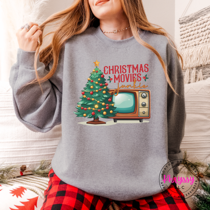 Close up of the Christmas movie junkie art on a Sport Gray crewneck sweatshirt.