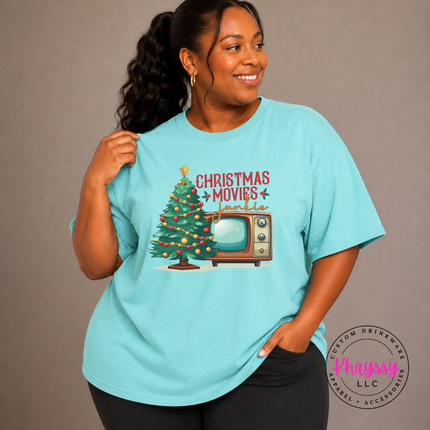Close up of the Christmas movie junkie art on a Chalky Mint tee.