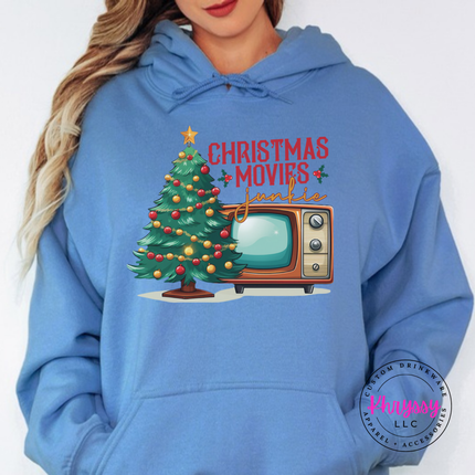 Model wearing the Christmas movie junkie hoodie in Carolina Blue.