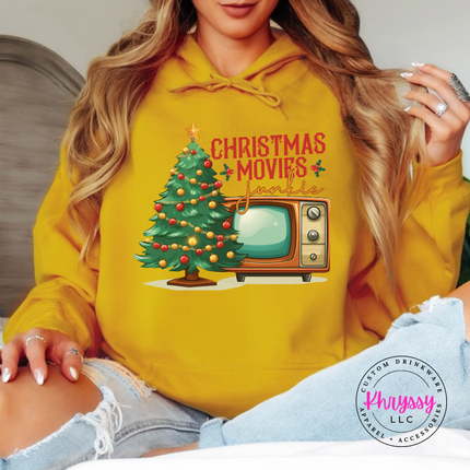 Close up of the Christmas movie junkie art on a Gold hoodie.