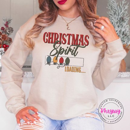 Close up of the Christmas Spirit Loading art on a Sand crewneck sweatshirt.