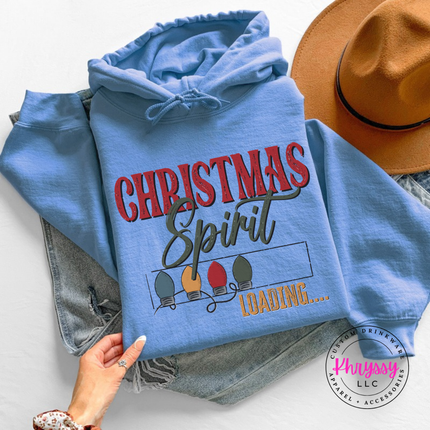 Model wearing the Christmas Spirit Loading hoodie in Carolina Blue.