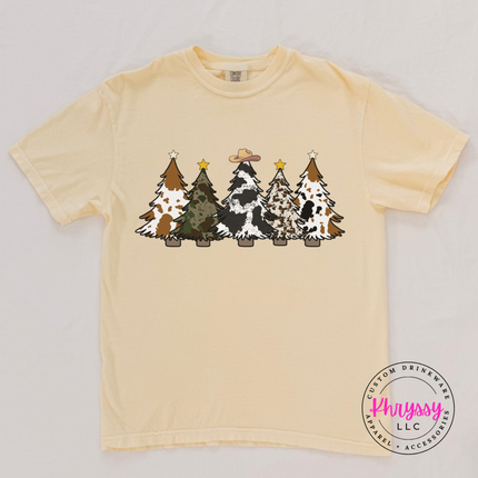 Model wearing the cow print trees tee in Butter.