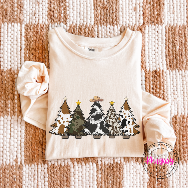 Model wearing the cow print trees long sleeve tee in Ivory.