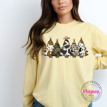 Model wearing the cow print trees long sleeve tee in Butter.