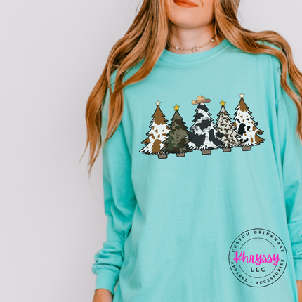 Close up of the cow print trees art on a Chalky Mint long sleeve tee.