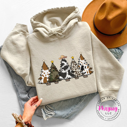 Close up of the cow print trees art on a Sand hoodie.