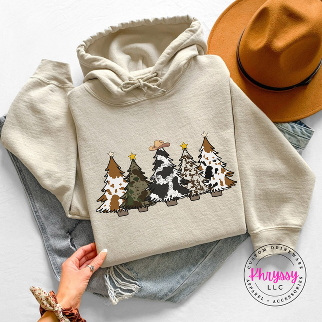 Close up of the cow print trees art on a Sand hoodie.
