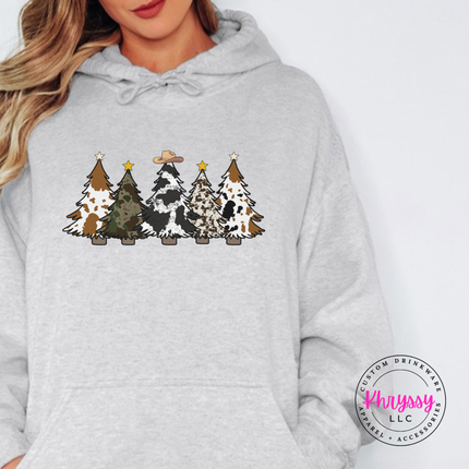 Ash hoodie featuring five cow print and leopard Christmas trees.