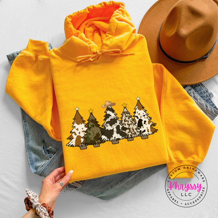 Gold hoodie showing patterned Christmas trees with a cowboy hat.