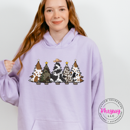 Model wearing the cow print trees hoodie in Orchid.