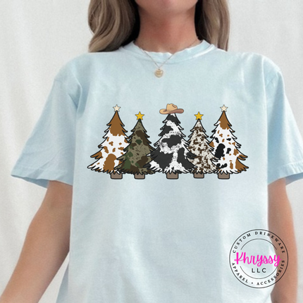 Chambray tee showing patterned Christmas trees with a cowboy hat.