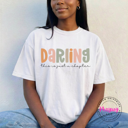 White tee with soft Darling lettering and a just-a-chapter script line