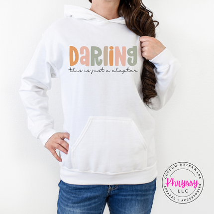 White hoodie with Darling lettering and a just-a-chapter script line