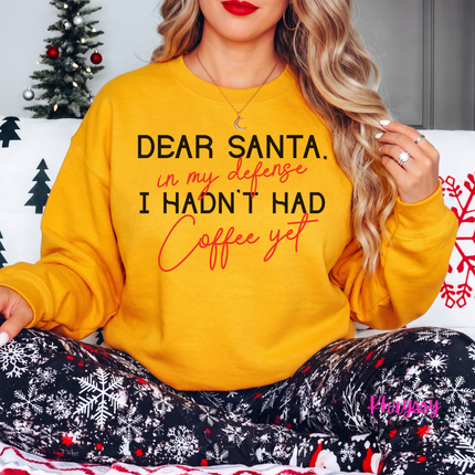 Woman wearing the Dear Santa coffee crewneck sweatshirt in Gold.