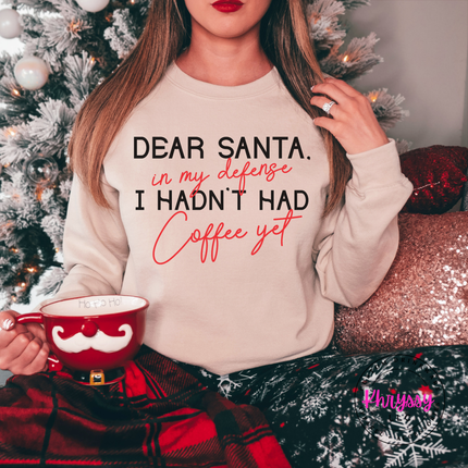 Woman wearing the Dear Santa coffee crewneck sweatshirt in Sand.