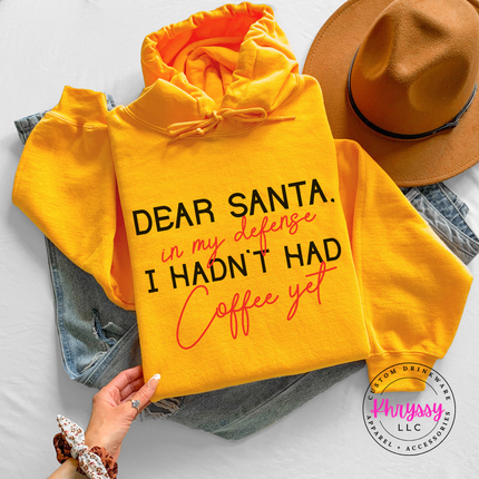 Woman wearing the Dear Santa coffee hoodie in Gold.