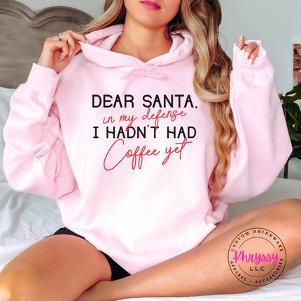 Close up of the Dear Santa coffee quote on a Light Pink hoodie.
