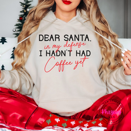 Woman wearing the Dear Santa coffee hoodie in Sand.