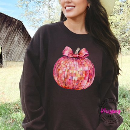 Woman wearing a Dark Chocolate crewneck sweatshirt with a disco pumpkin design.