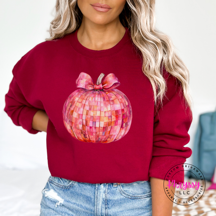 Garnet crewneck sweatshirt featuring a pink mosaic pumpkin with a bow.
