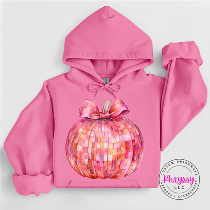 Woman wearing an Azalea pullover hoodie with a pink disco pumpkin design.