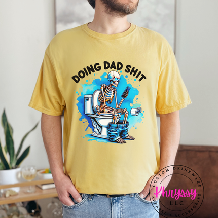 Person wearing a yellow t-shirt with a graphic design and text, standing in a casual indoor setting.