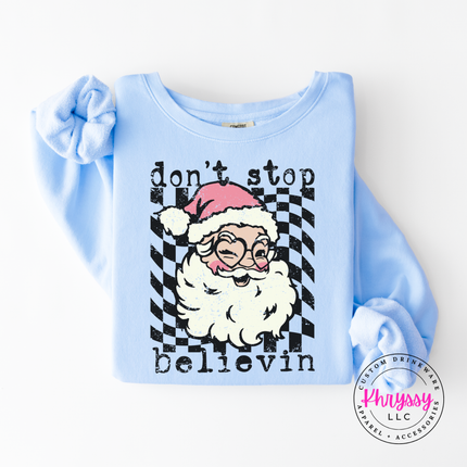 Flat lay of the retro believing Santa Christmas long sleeve tee in Hydrangea.