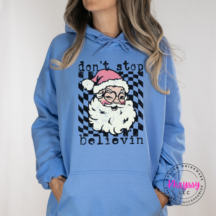Model wearing the retro believing Santa hoodie in Carolina Blue.