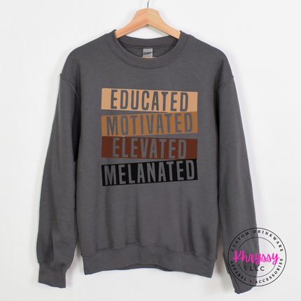 Charcoal crewneck sweatshirt featuring the bold empowerment Educated Motivated Elevated Melanated bars.