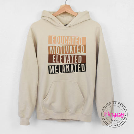 Sand Gildan hoodie showing bold stacked bar Educated Motivated Elevated Melanated typography.