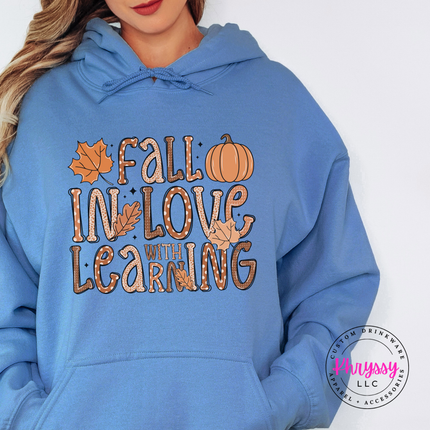 Light Blue hoodie with the Fall in love with learning teacher graphic