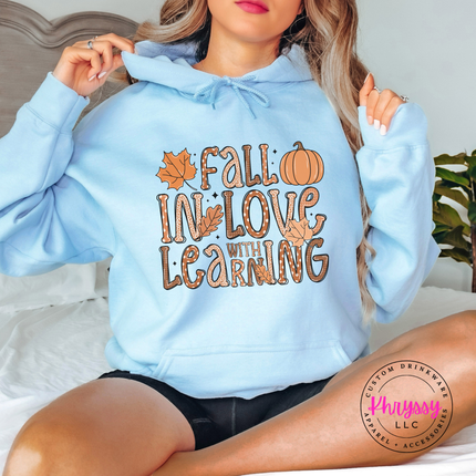 Light Blue hoodie with the Fall in love with learning teacher graphic