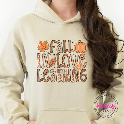 Sand hoodie featuring dotted bubble letters and maple leaves illustration.