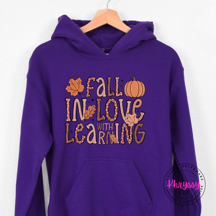 Purple colored hoodie featuring a pumpkin and fall leaves design.